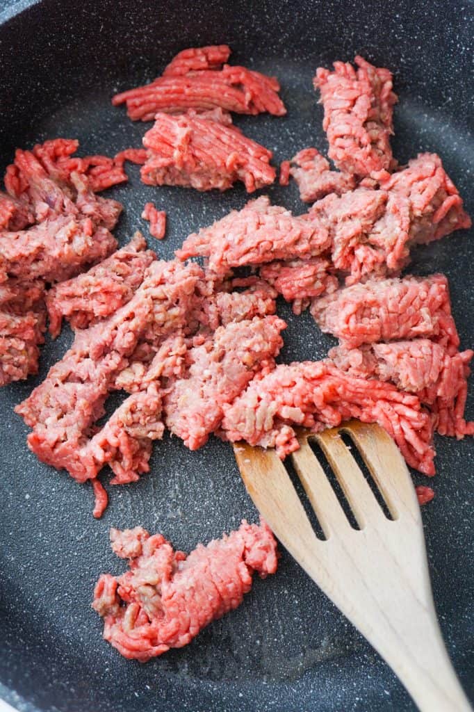 raw ground beef in a saute pan