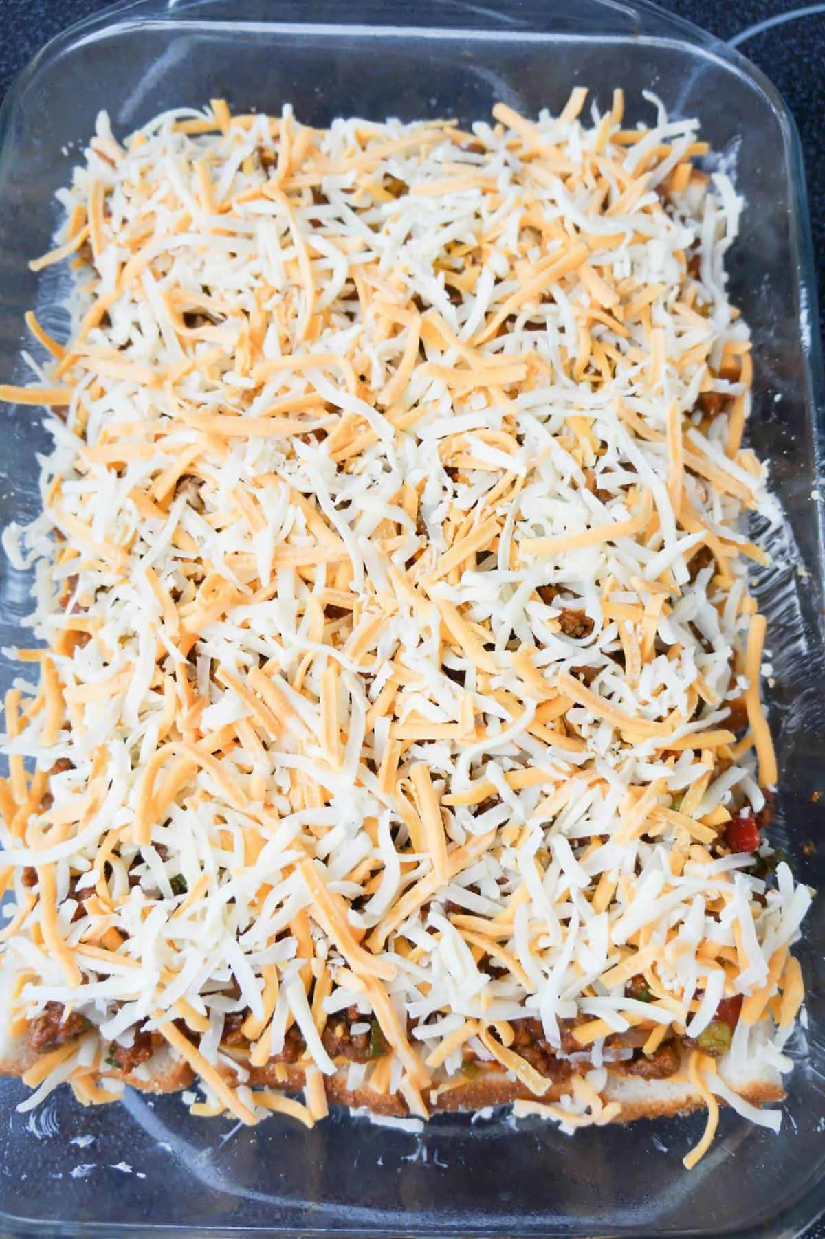 shredded cheese on top of ground beef taco meat