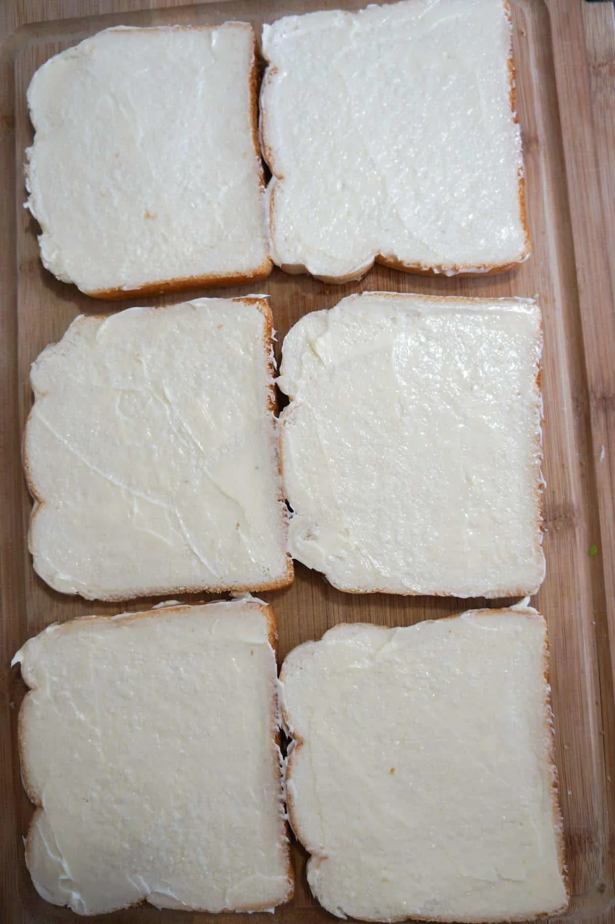 bread sliced spread with margarine on a cutting board