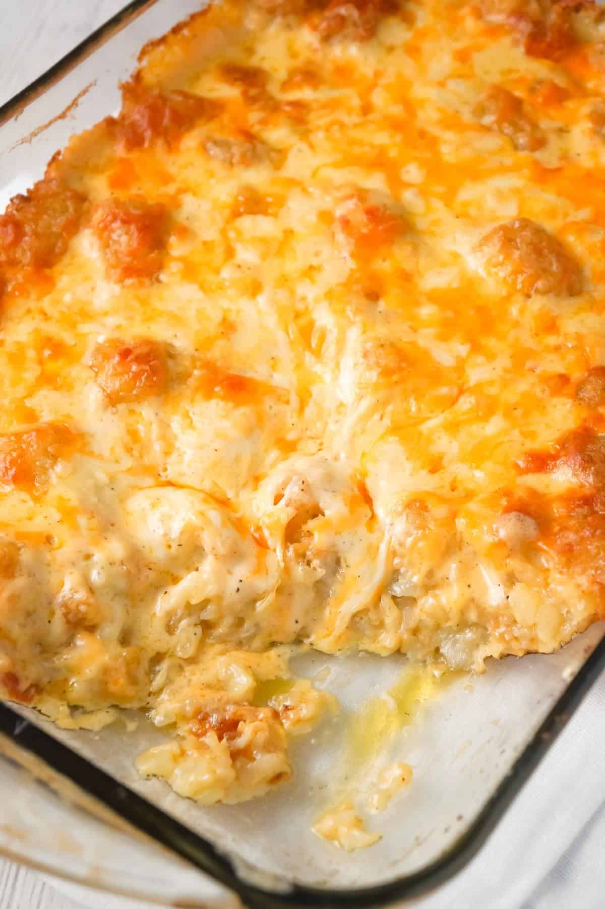 Cheesy Garlic Tater Tot Casserole is an easy potato side dish recipe using heavy cream, cheddar cheese soup, frozen tater tots, garlic puree and shredded mozzarella, cheddar and Parmesan cheese.