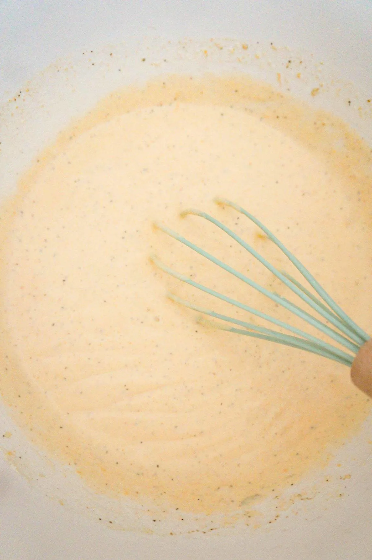 creamy garlic cheese sauce in a mixing bowl