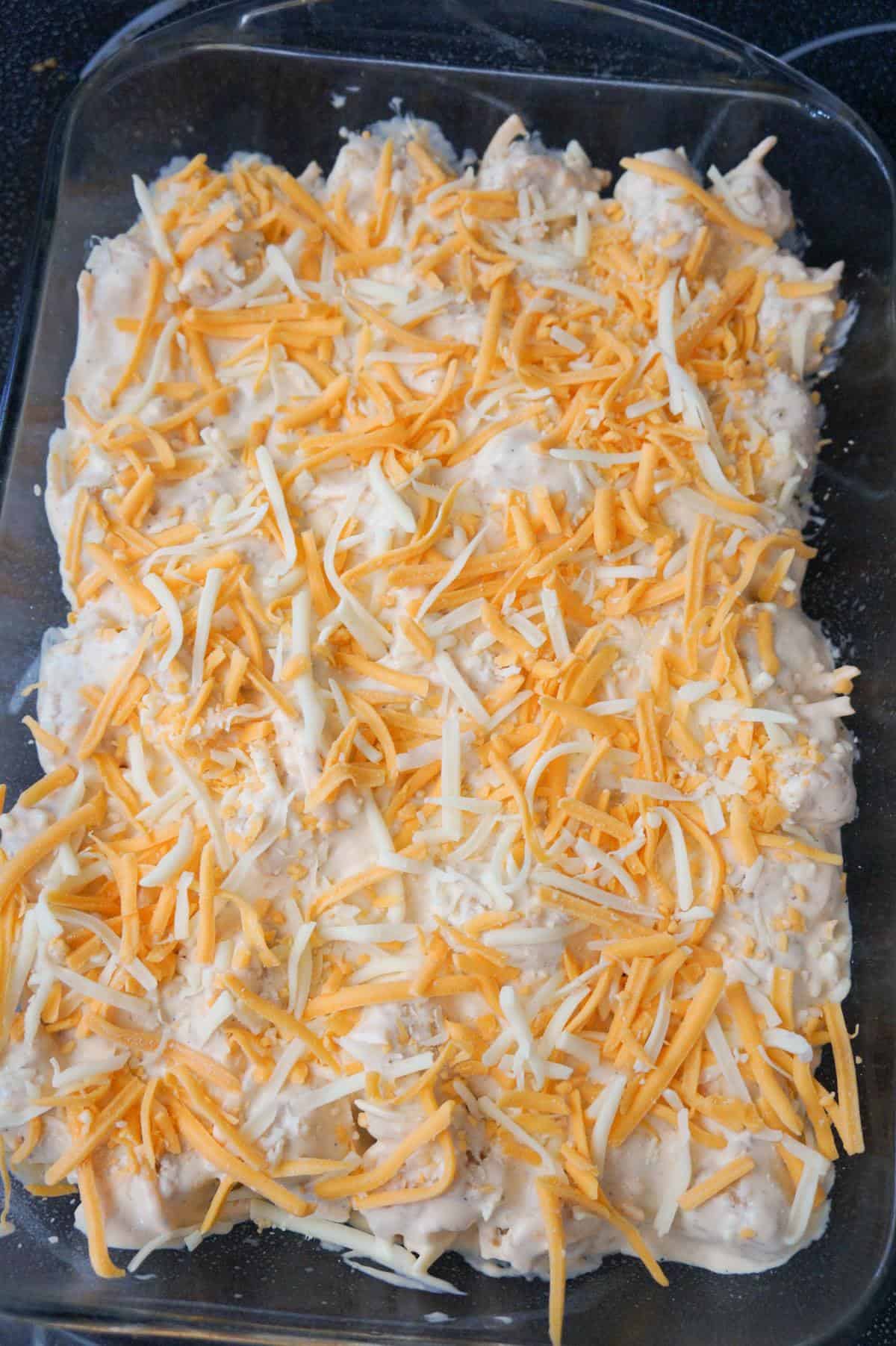 shredded cheddar and mozzarella on top of tater tot casserole before baking