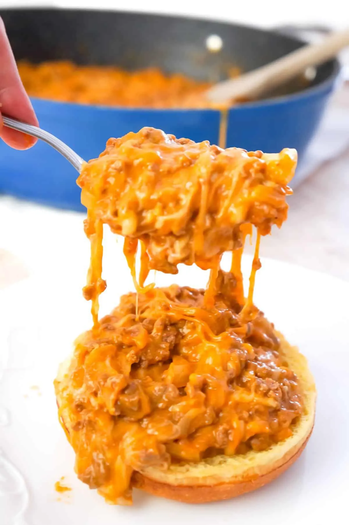 Cheesy Sloppy Joes are an easy weeknight dinner recipe using ground beef tossed in sloppy joe sauce, condensed cheddar cheese soup and shredded mozzarella and cheddar cheese all piled on to toasted brioche buns.