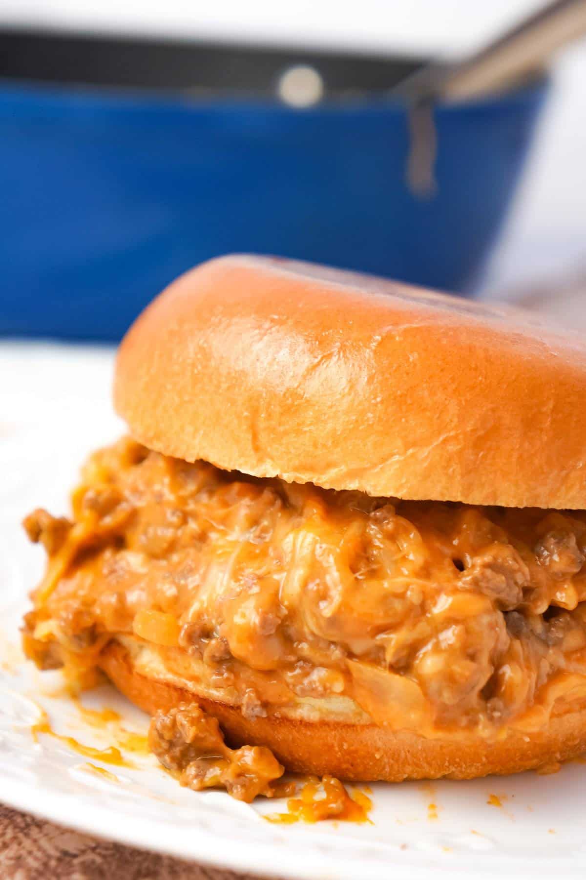 Cheesy Sloppy Joes are an easy weeknight dinner recipe using ground beef tossed in sloppy joe sauce, condensed cheddar cheese soup and shredded mozzarella and cheddar cheese all piled on to toasted brioche buns.