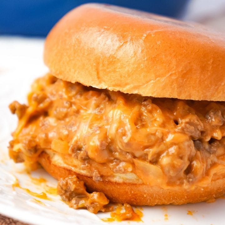 Cheesy Sloppy Joes are an easy weeknight dinner recipe using ground beef tossed in sloppy joe sauce, condensed cheddar cheese soup and shredded mozzarella and cheddar cheese all piled on to toasted brioche buns.