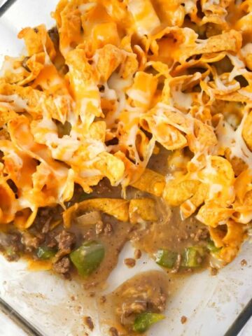 Philly Cheese Steak Frito Pie is an easy ground beef casserole recipe loaded with green peppers, onions, Fritos corn chips and shredded mozzarella and cheddar cheese.