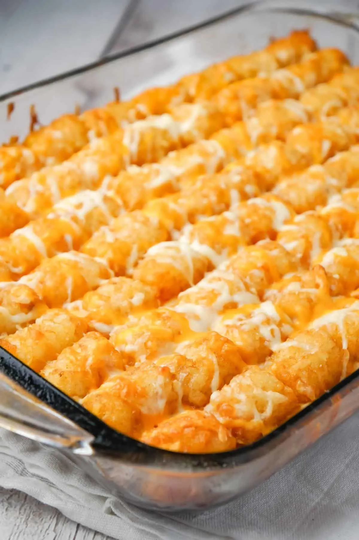 Dr Pepper Pork Tater Tot Casserole is a hearty dish with a base of ground pork cooked in Dr Pepper and BBQ sauce and topped with tater tots and shredded cheese.