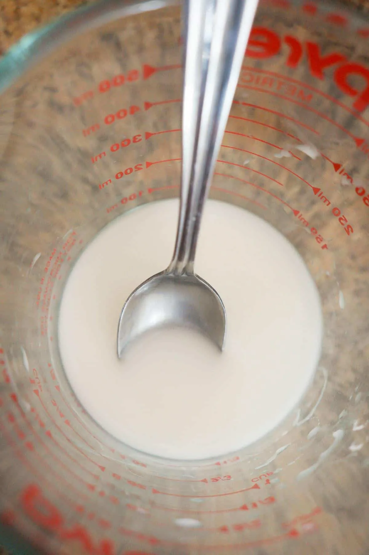 water and cornstarch mixture in a glass measuring cup
