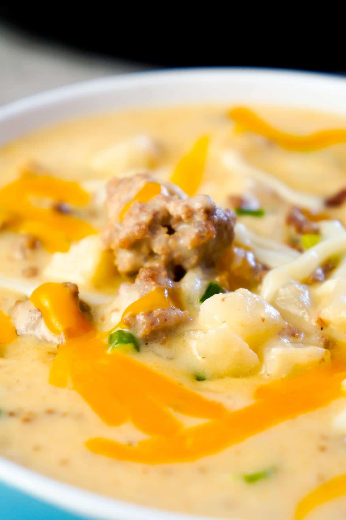 Instant Pot Bacon Cheeseburger Soup with Potatoes is a hearty pressure cooker soup recipe loaded with ground beef, crumbled bacon, diced hash brown potatoes, chopped green onions and cheddar cheese.