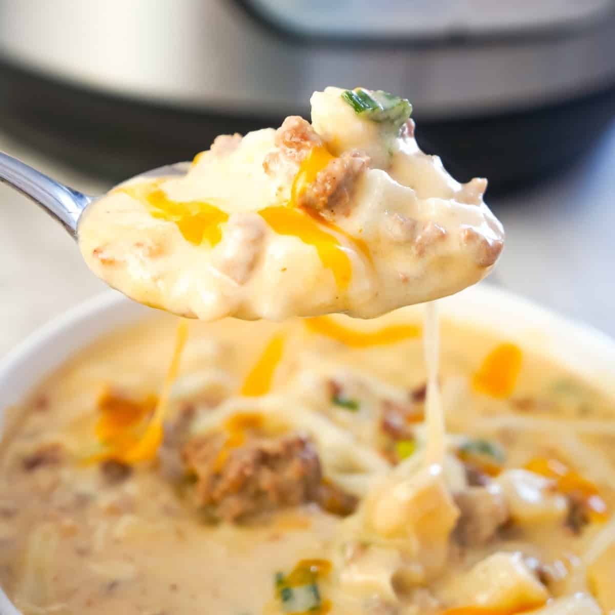 Instant Pot Bacon Cheeseburger Soup with Potatoes is a hearty pressure cooker soup recipe loaded with ground beef, crumbled bacon, diced hash brown potatoes, chopped green onions and cheddar cheese.