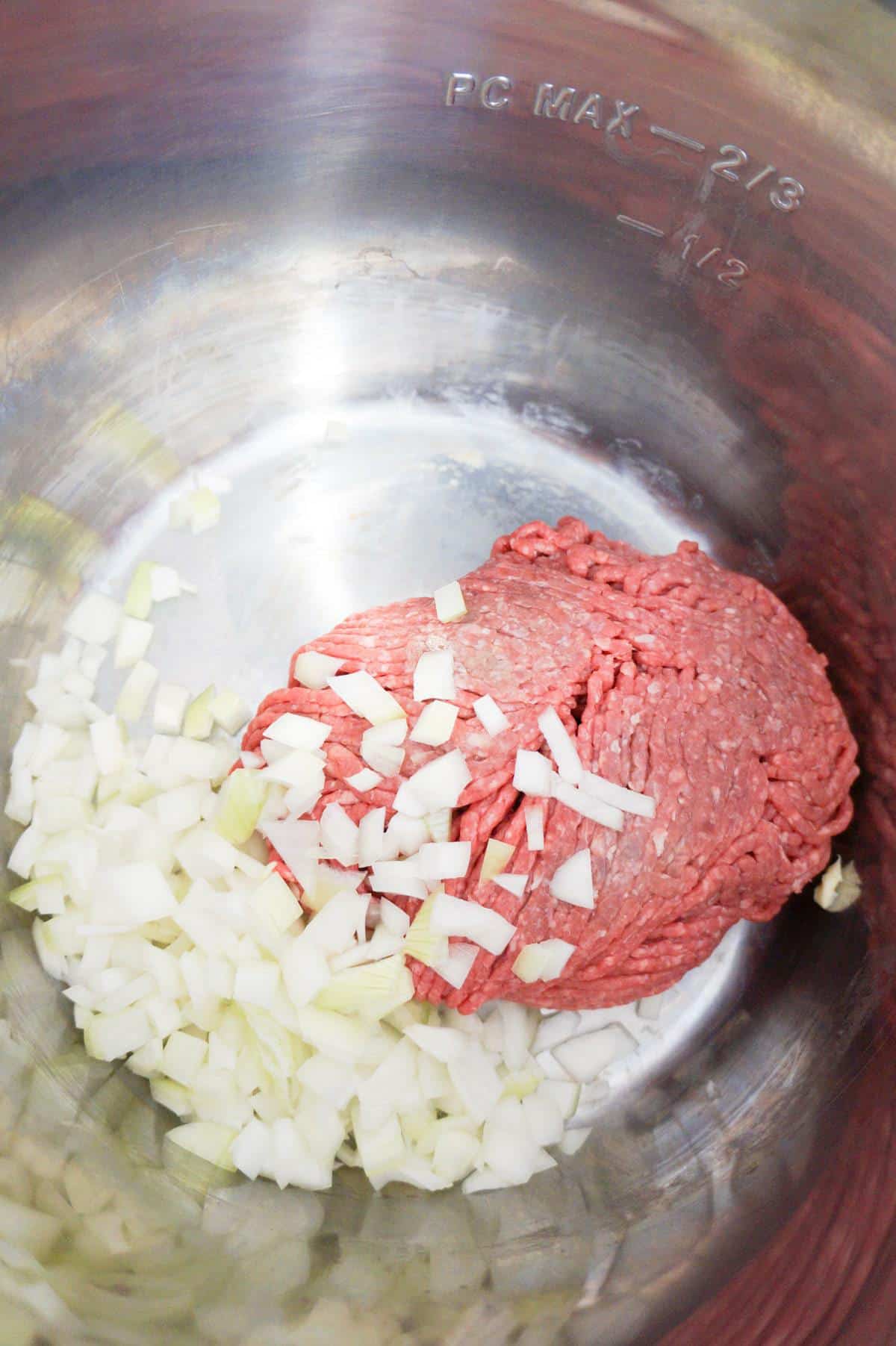 diced onions and raw ground beef in an Instant Pot
