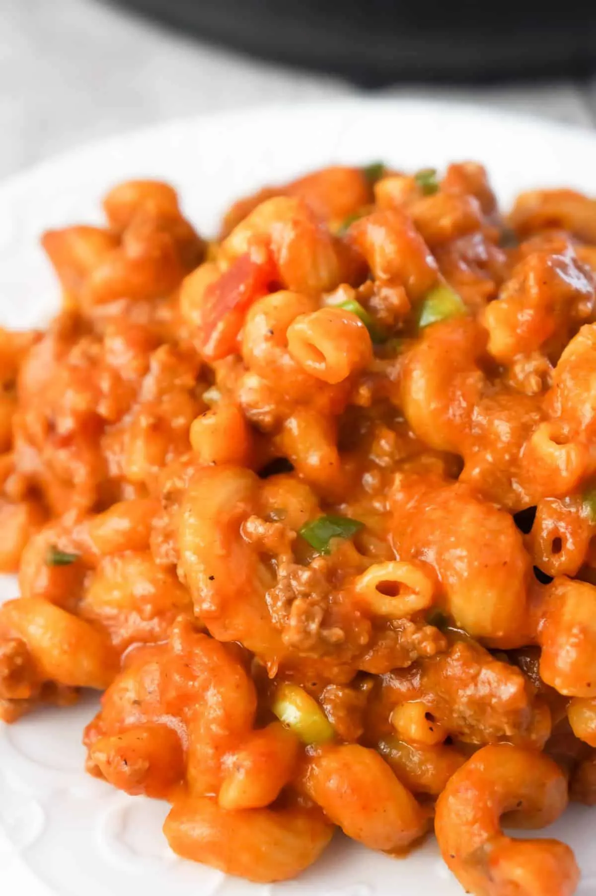 Instant Pot Cheesy Taco Pasta is a delicious pressure cooker pasta recipe loaded with ground beef, salsa, chili sauce, taco seasoning, chopped green onions and shredded cheese.