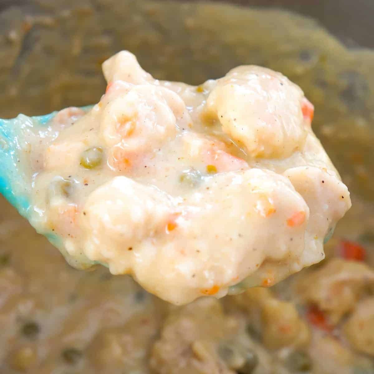 Instant Pot Chicken and Dumplings with Biscuits is an easy dump and start recipe using boneless, skinless chicken breasts, cream of chicken soup, Pillsbury refrigerated biscuits and canned peas and carrots.