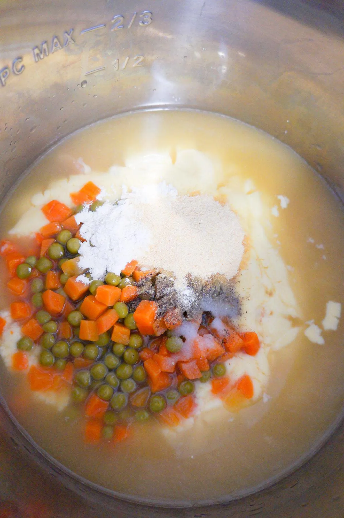 cream of chicken soup, canned peas and carrots and spices in an Instant Pot