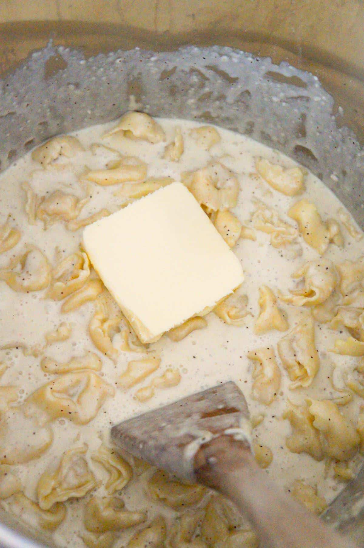 butter on top of Alfredo pasta in an Instant Pot