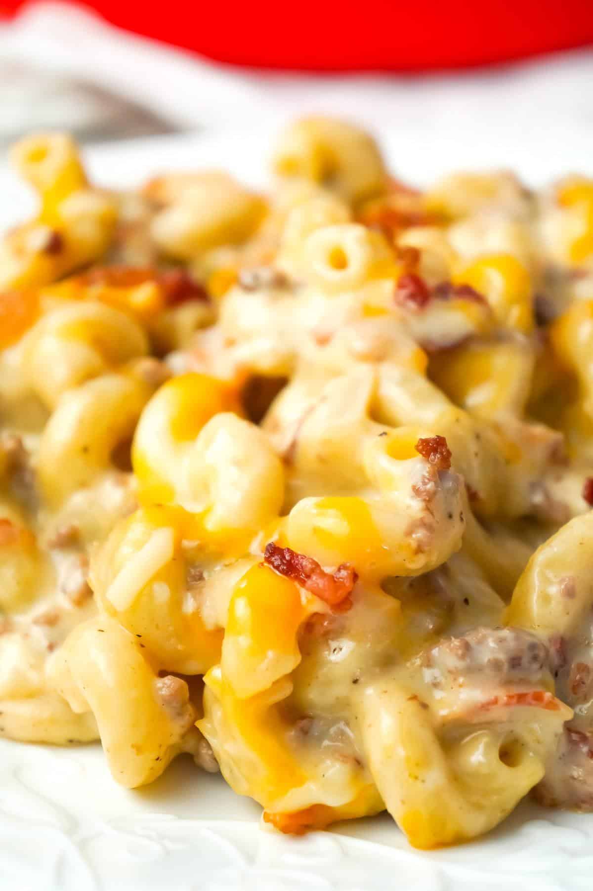 One Pot Bacon Cheeseburger Pasta is a creamy pasta recipe loaded with ground beef, crumbled bacon, mozzarella and cheddar cheese.