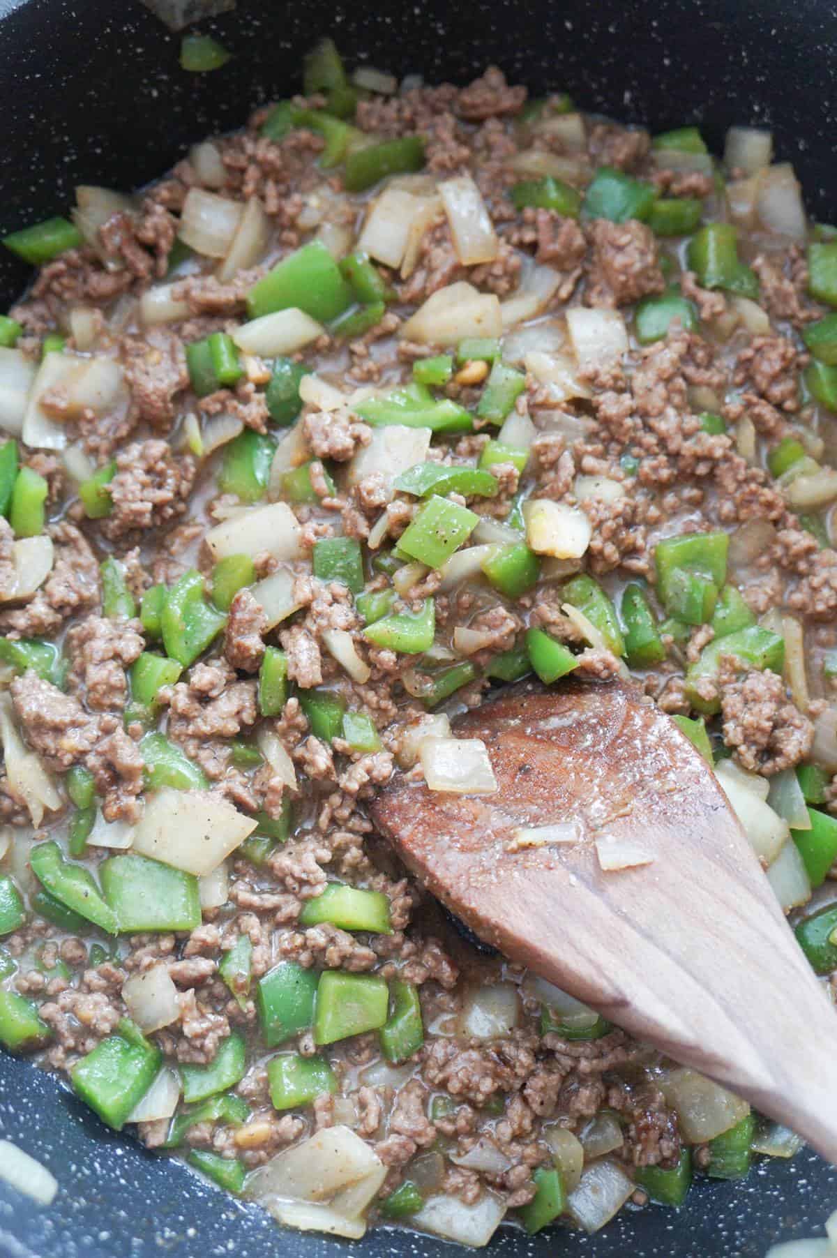 ground beef, diced onions and diced green peppers in a saute pan
