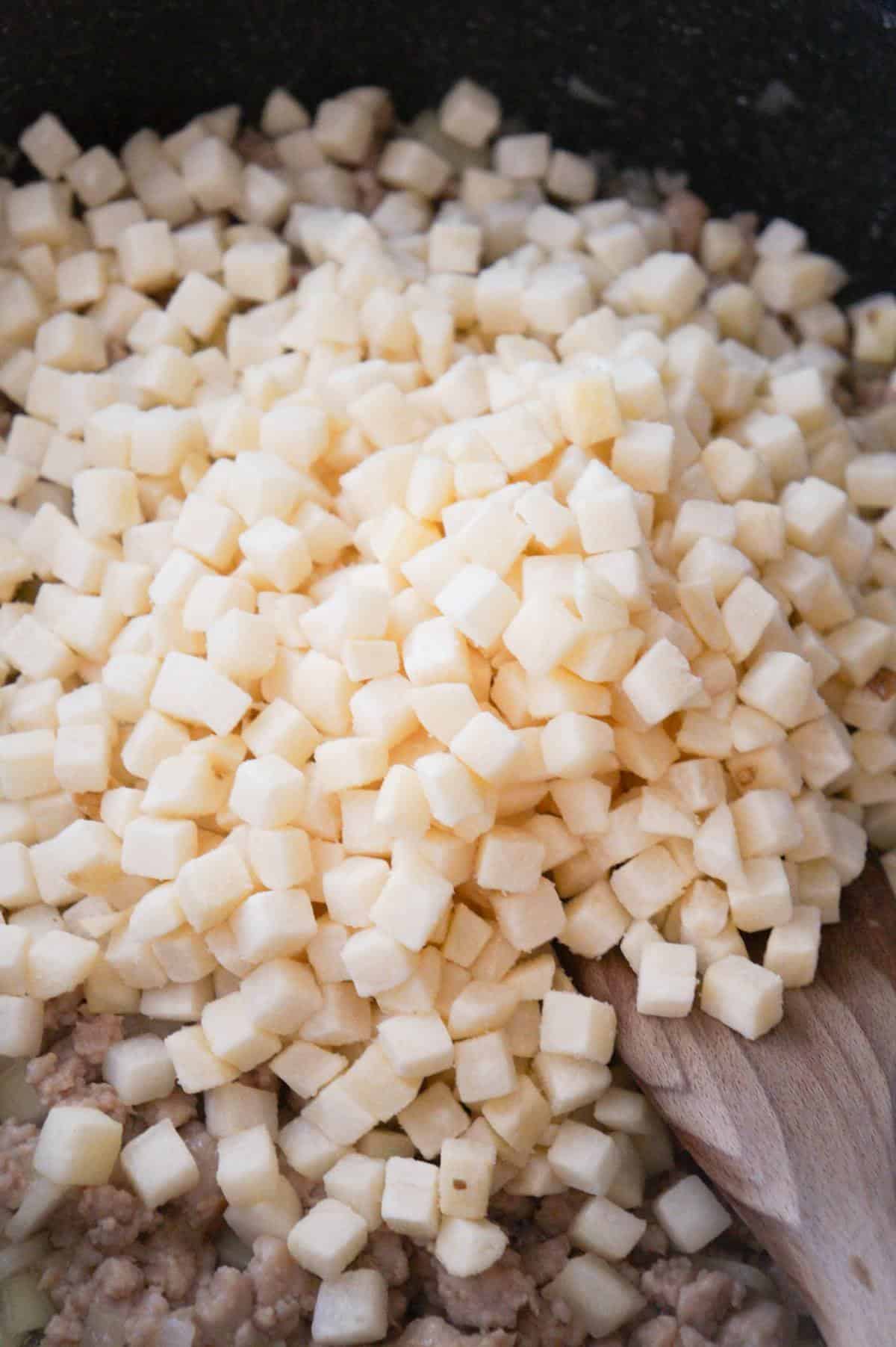 frozen diced potatoes in a saute pan