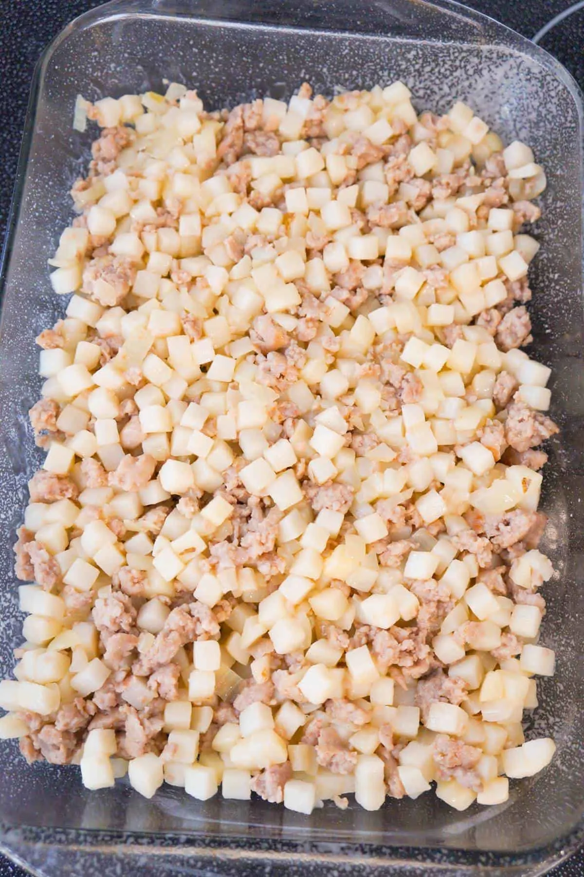 sausage meat and diced potatoes in a baking dish