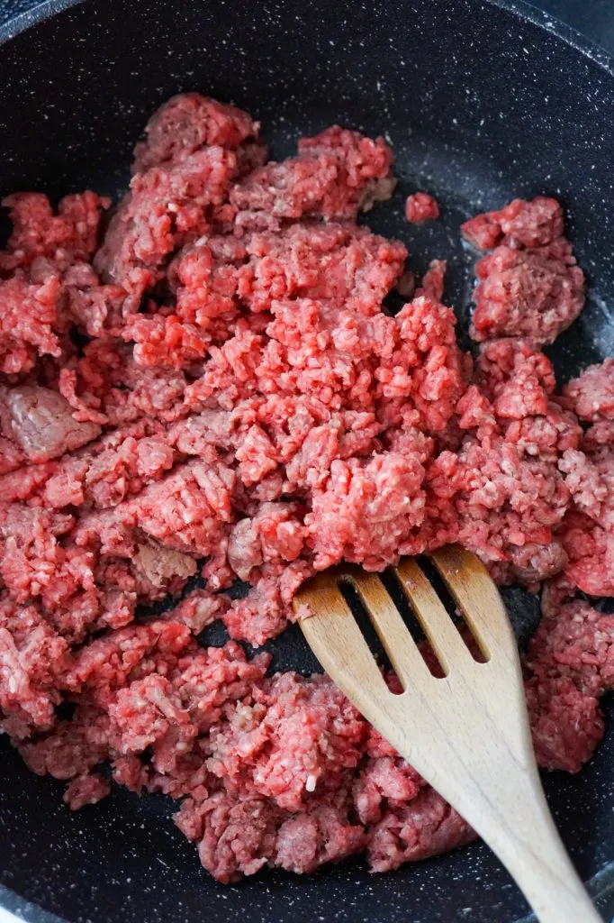 raw ground beef in a saute pan