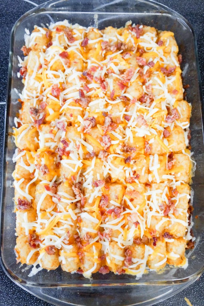 crumbled bacon and shredded cheese on top of tater tot casserole
