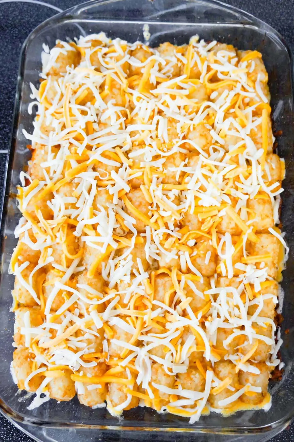 shredded cheese on top of tater tot casserole