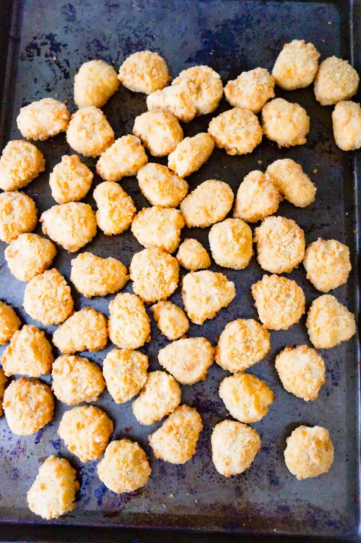 cooked popcorn chicken on a baking sheet