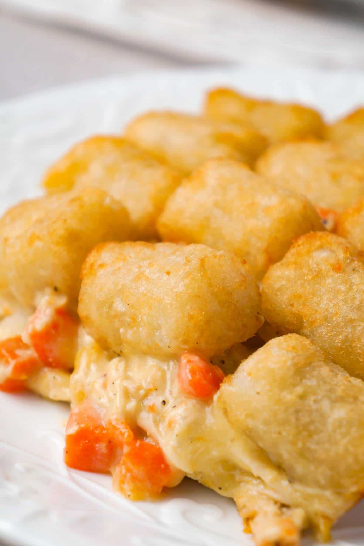 Chicken Pot Pie Tater Tot Casserole is an easy dinner recipe using shredded rotisserie chicken tossed with cream of chicken soup and mixed veggies all topped with tater tots.