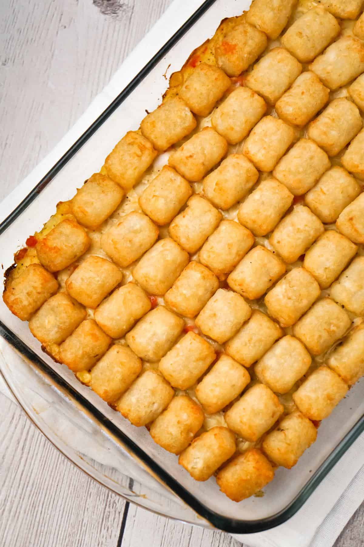 Chicken Pot Pie Tater Tot Casserole is an easy dinner recipe using shredded rotisserie chicken tossed with cream of chicken soup and mixed veggies all topped with tater tots.