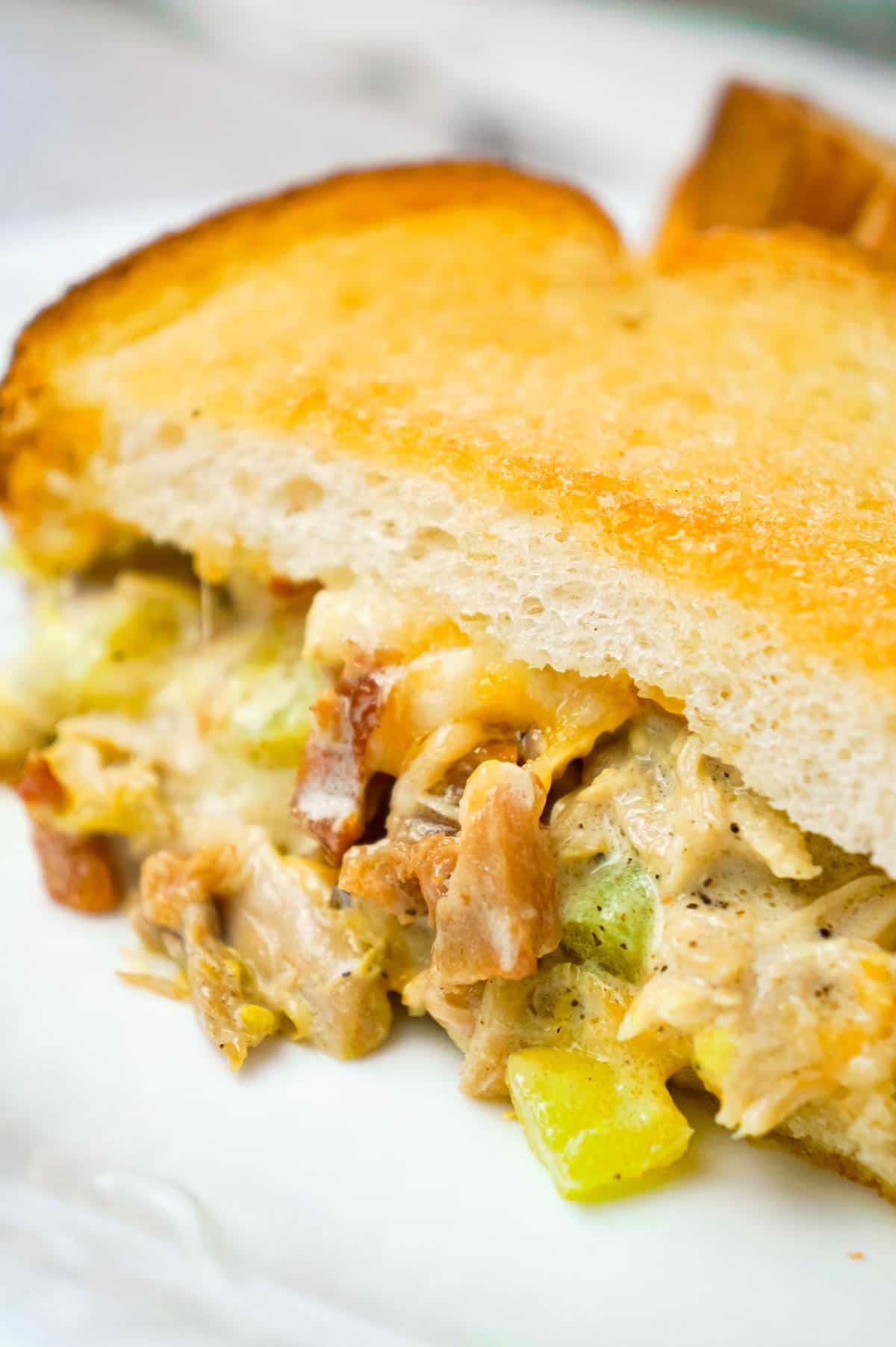 Dill Pickle Chicken Grilled Cheese Casserole is a delicious dinner recipe loaded with shredded chicken, diced dill pickles, crumbled bacon, ranch dressing and cheese all in between layers of toasted bread.
