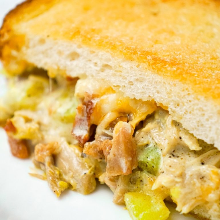 Dill Pickle Chicken Grilled Cheese Casserole is a delicious dinner recipe loaded with shredded chicken, diced dill pickles, crumbled bacon, ranch dressing and cheese all in between layers of toasted bread.