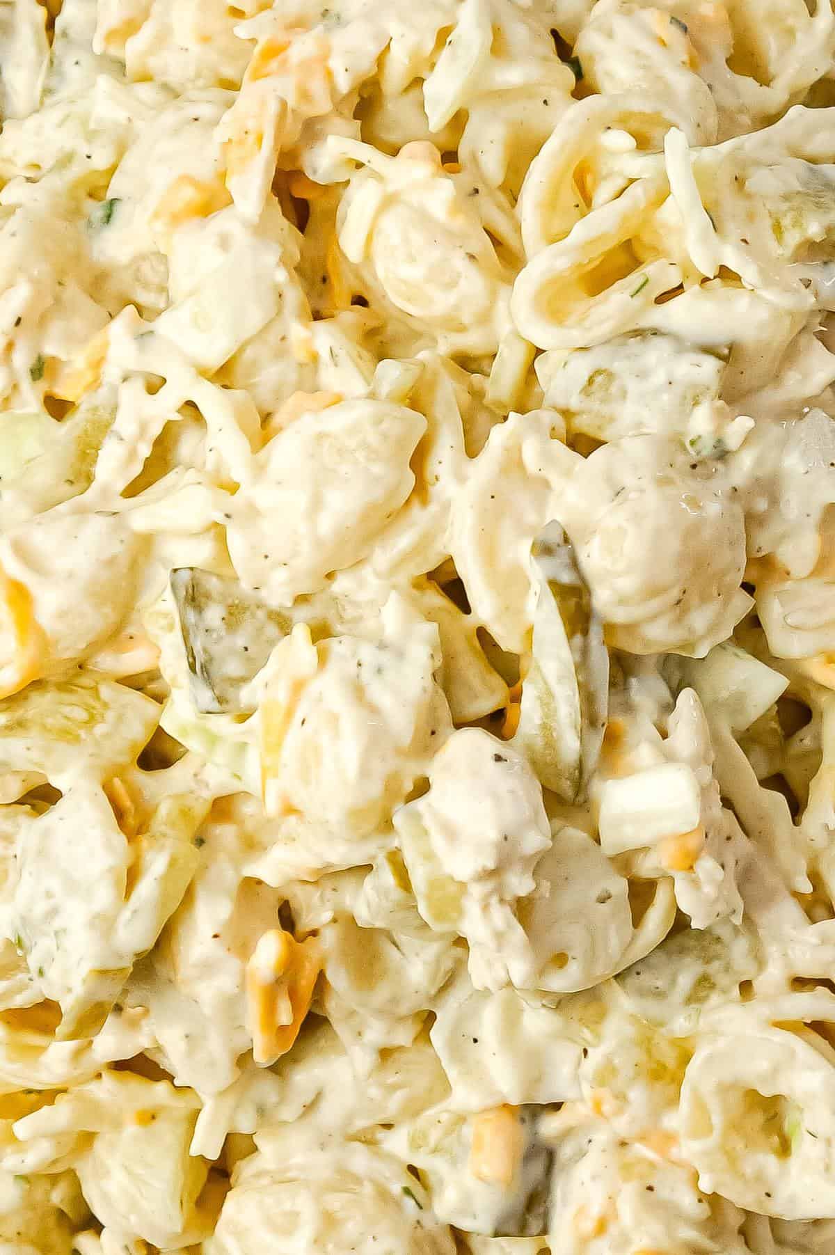 Dill Pickle Chicken Pasta Salad is a delicious cold side dish recipe loaded with shredded chicken, diced dill pickles, mayo, ranch dressing and shredded cheese.