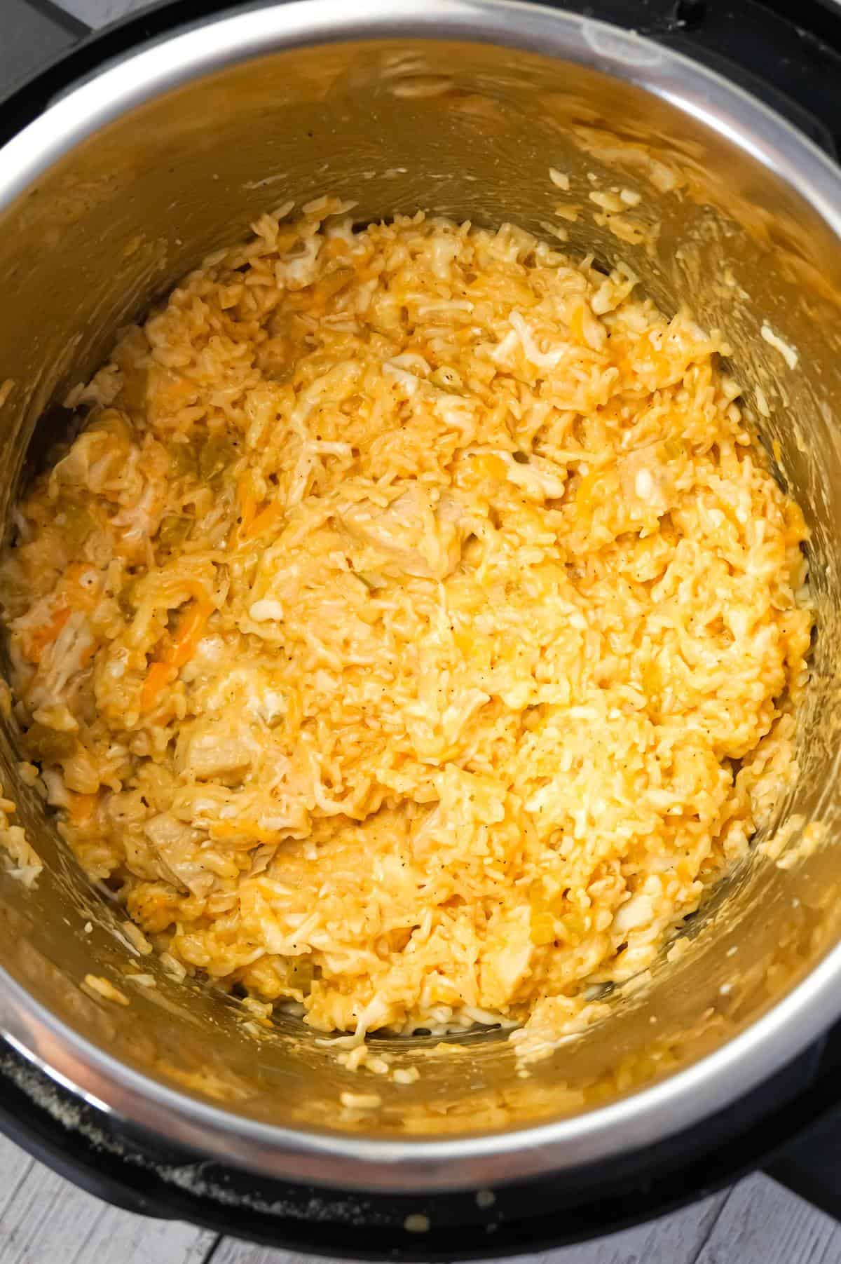 Instant Pot Cheesy Buffalo Chicken and Rice is an easy pressure cooker dinner recipe loaded with chicken breast chunks, long grain white rice, diced celery, buffalo sauce and shredded cheese.