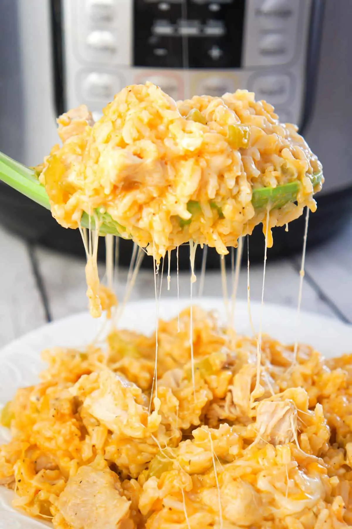 Instant Pot Cheesy Buffalo Chicken and Rice is an easy pressure cooker dinner recipe loaded with chicken breast chunks, long grain white rice, diced celery, buffalo sauce and shredded cheese.