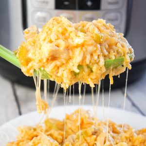 Instant Pot Cheesy Buffalo Chicken and Rice is an easy pressure cooker dinner recipe loaded with chicken breast chunks, long grain white rice, diced celery, buffalo sauce and shredded cheese.