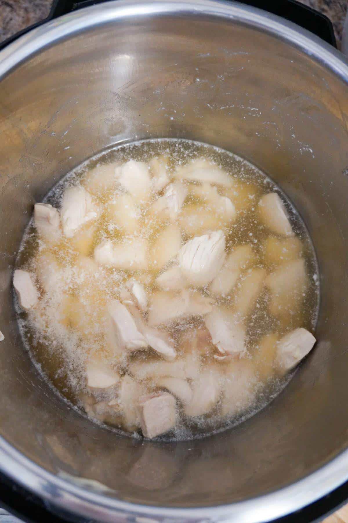 chicken breast chunks in broth in an Instant Pot