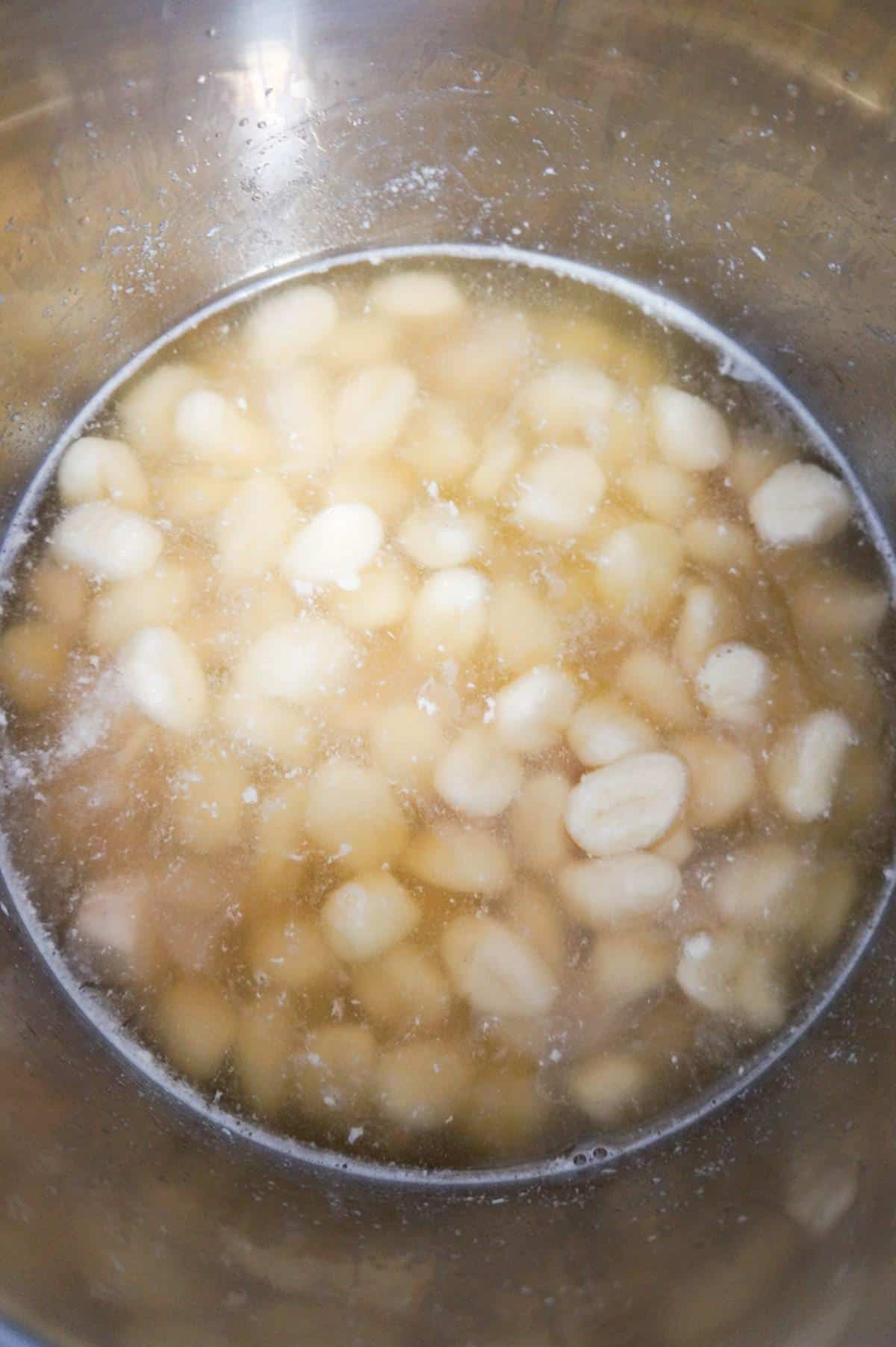 gnocchi and chicken breast chunks in broth in an Instant Pot