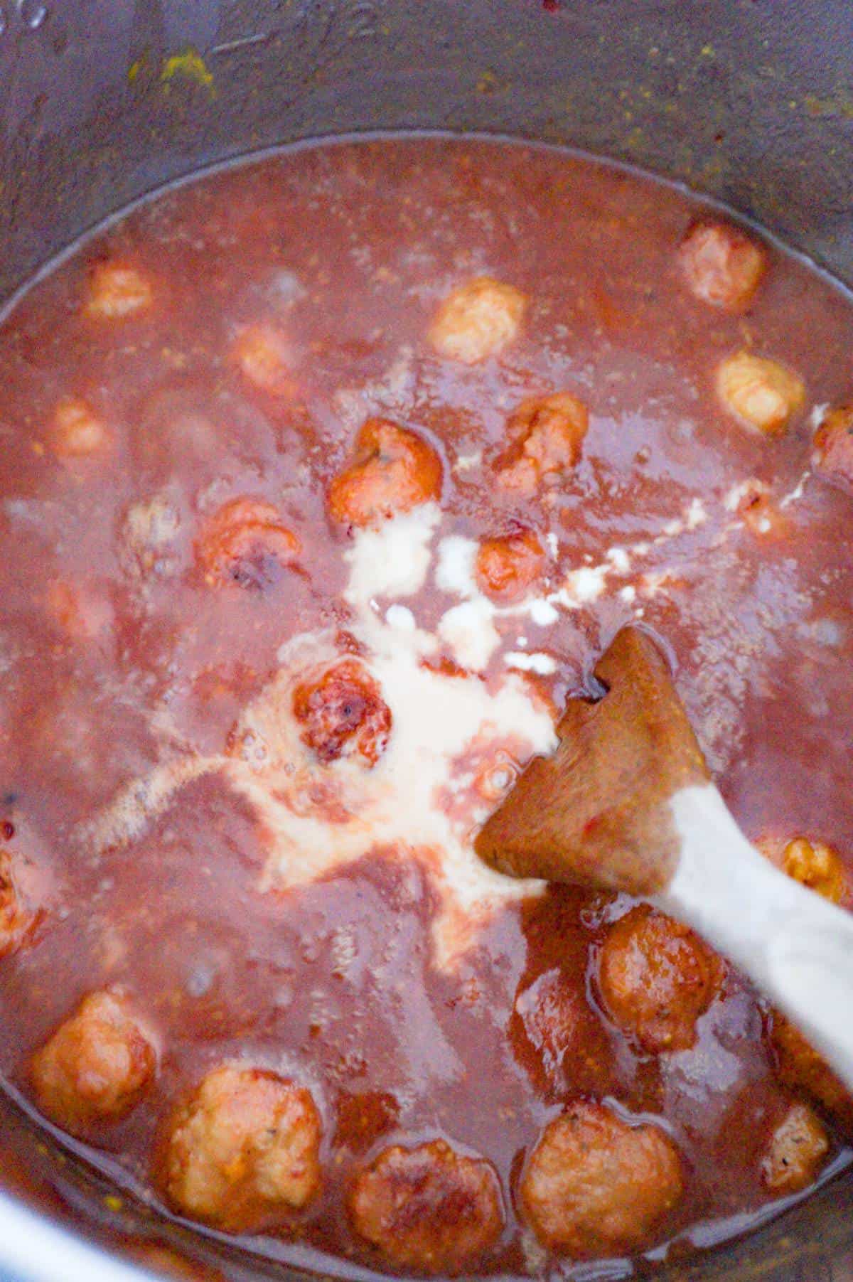 cornstarch and water added to cranberry mustard meatballs in an Instant Pot