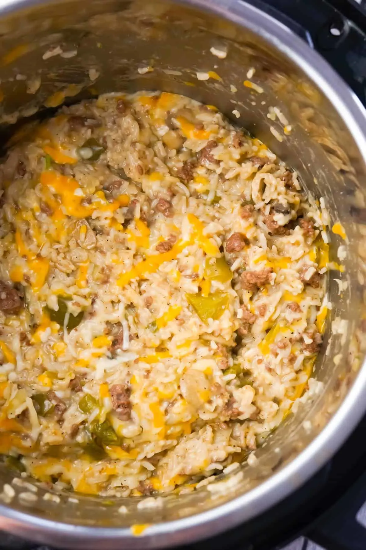 Instant Pot Philly Cheese Steak Ground Beef and Rice is an easy ground beef dinner recipe loaded with long grain white rice, green peppers, onions, mushrooms and shredded cheese.