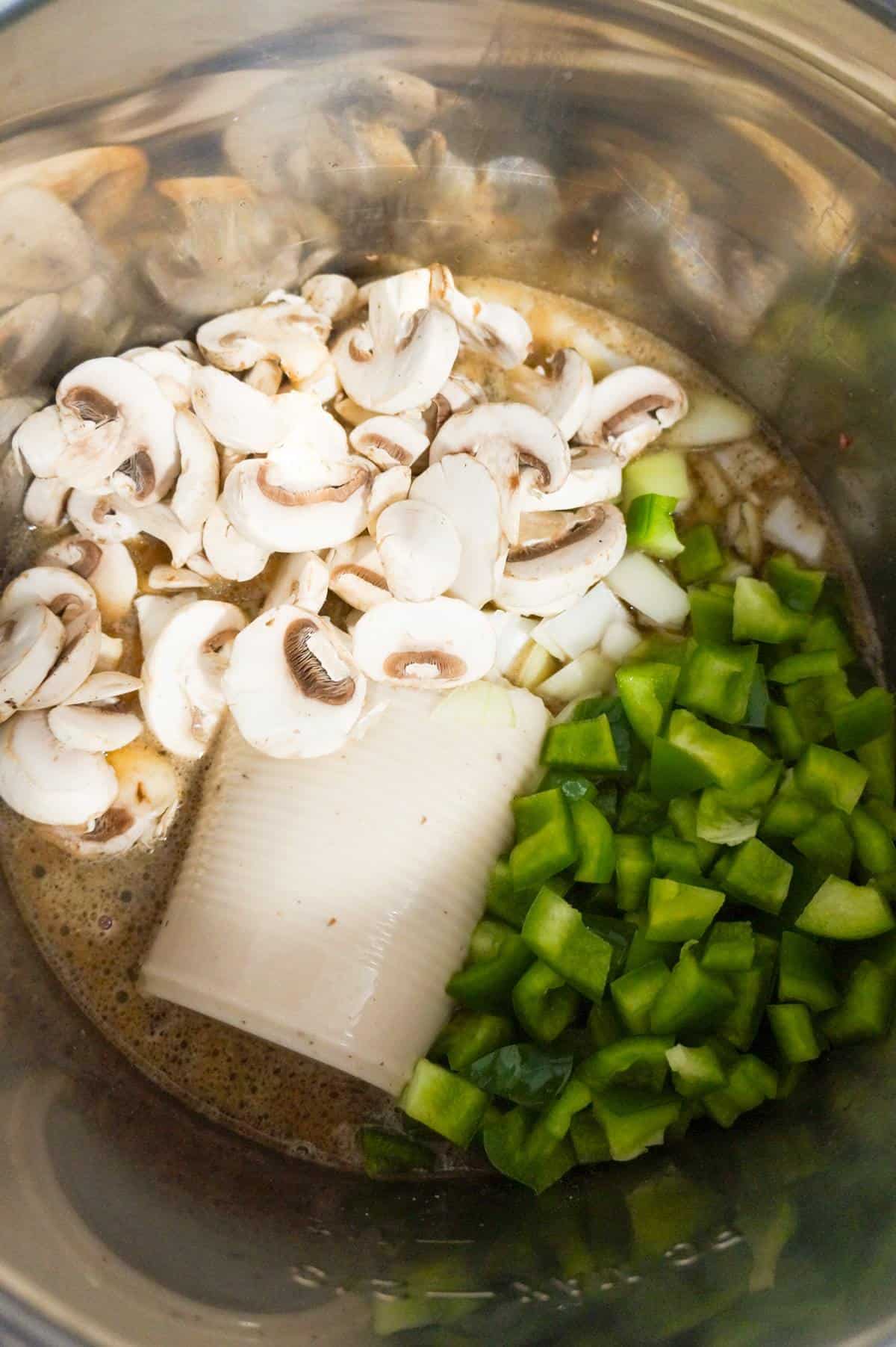 sliced mushrooms, diced green peppers and cream of mushroom soup in an Instant Pot