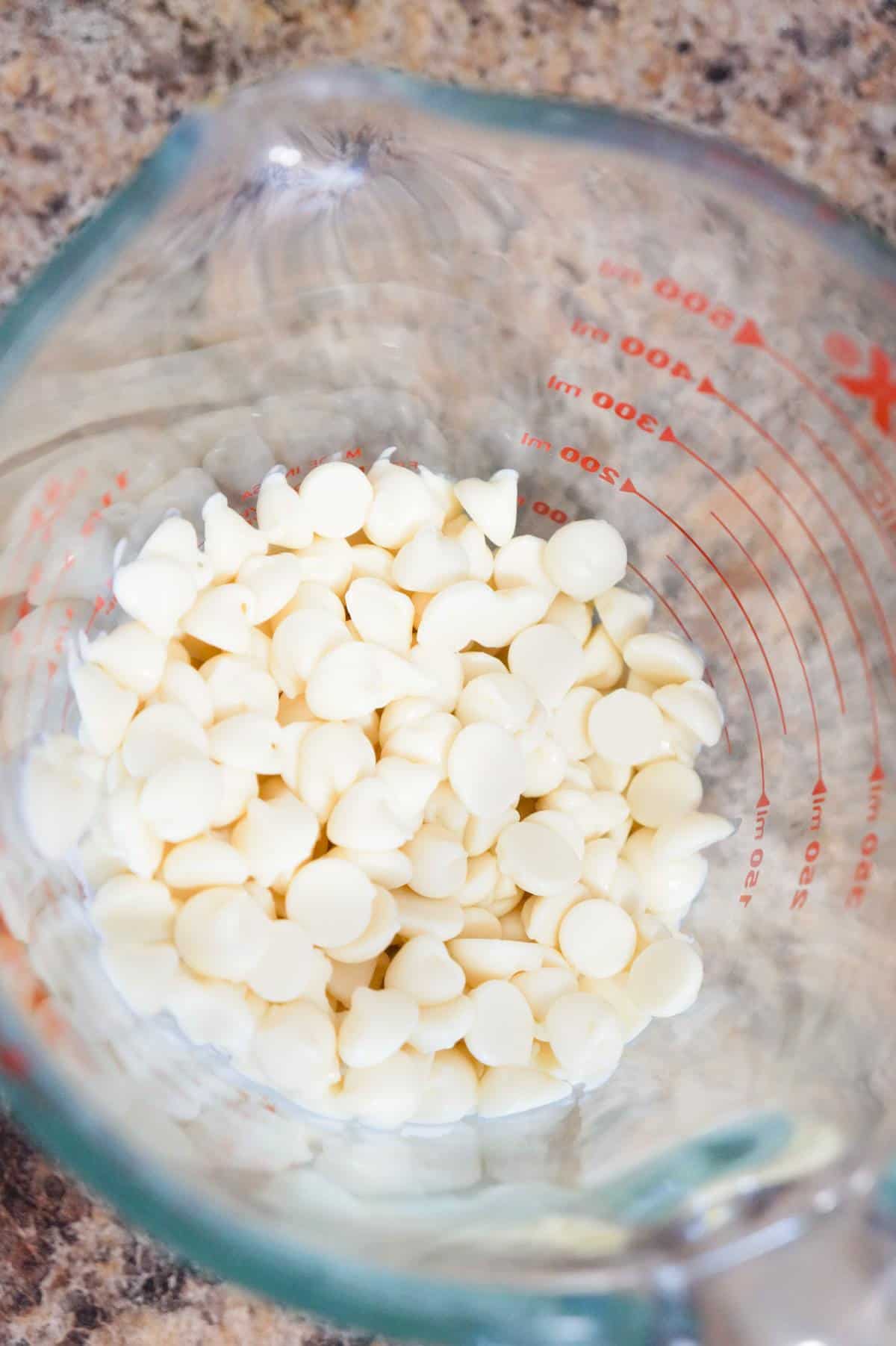 white chocolate chips in a glass measuring cup