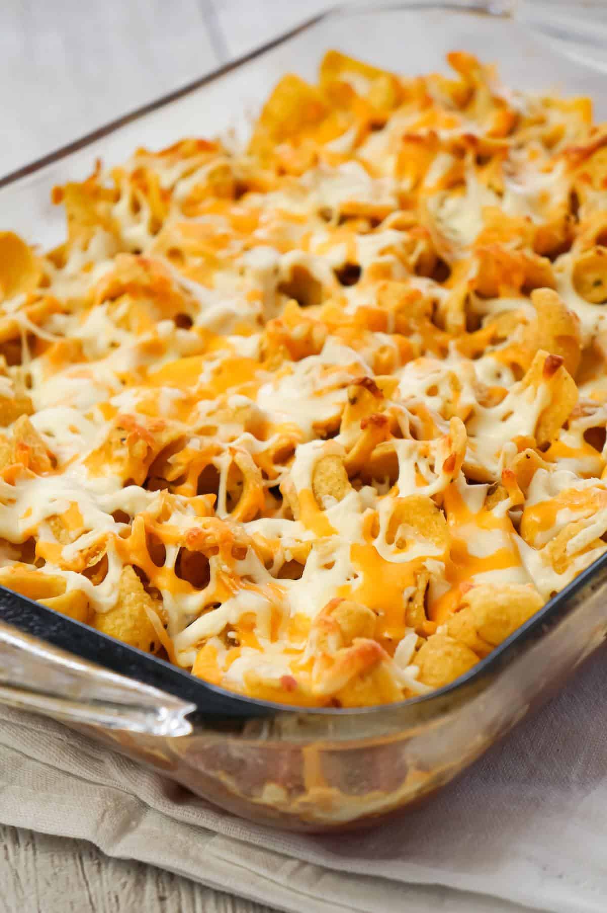 Sausage and Peppers Frito Pie is a delicious casserole recipe made with Italian pork sausage meat, onions and bell pepper tossed in a sweet and spicy tomato sauce and topped with Fritos corn chips and shredded cheese.