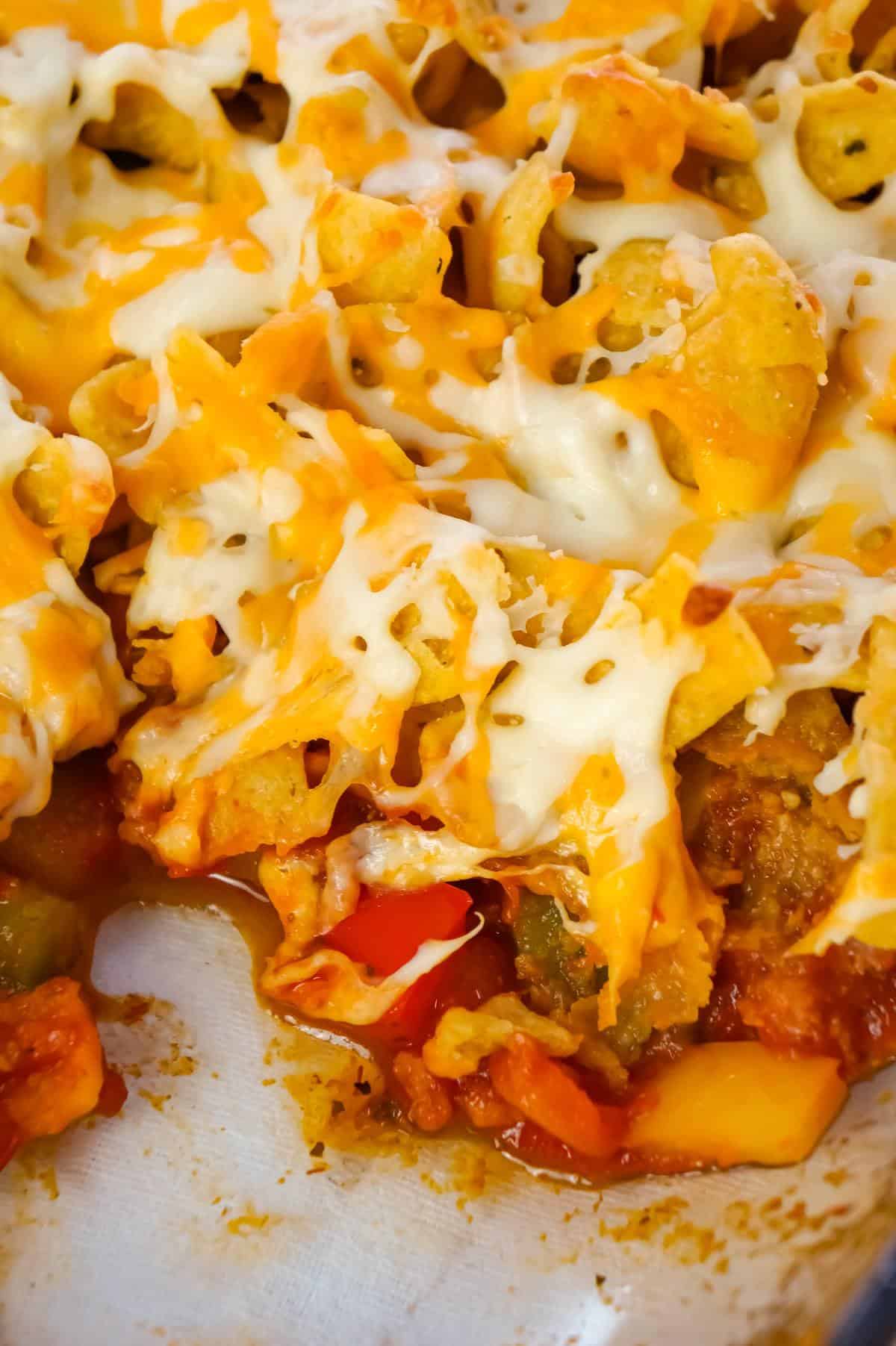 Sausage and Peppers Frito Pie is a delicious casserole recipe made with Italian pork sausage meat, onions and bell pepper tossed in a sweet and spicy tomato sauce and topped with Fritos corn chips and shredded cheese.