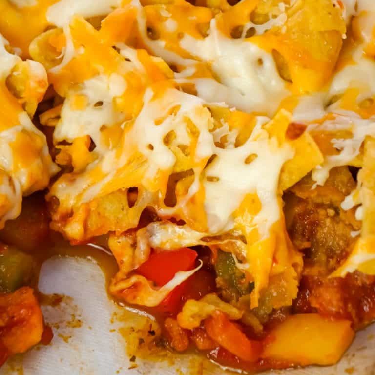 Sausage and Peppers Frito Pie is a delicious casserole recipe made with Italian pork sausage meat, onions and bell pepper tossed in a sweet and spicy tomato sauce and topped with Fritos corn chips and shredded cheese.