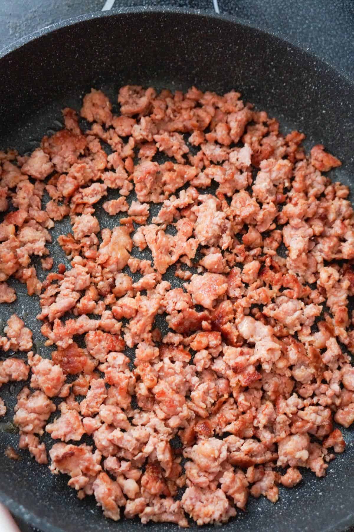 cooked ground sausage meat in a saute pan