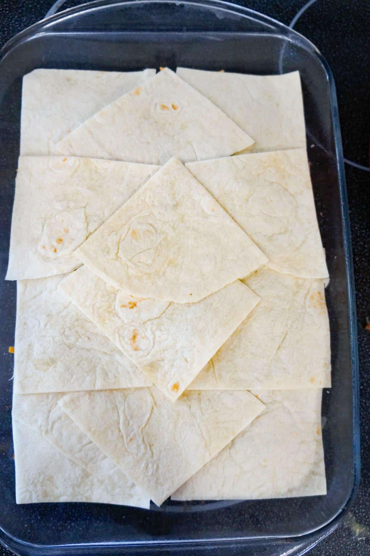 flour tortilla quarters in a baking dish