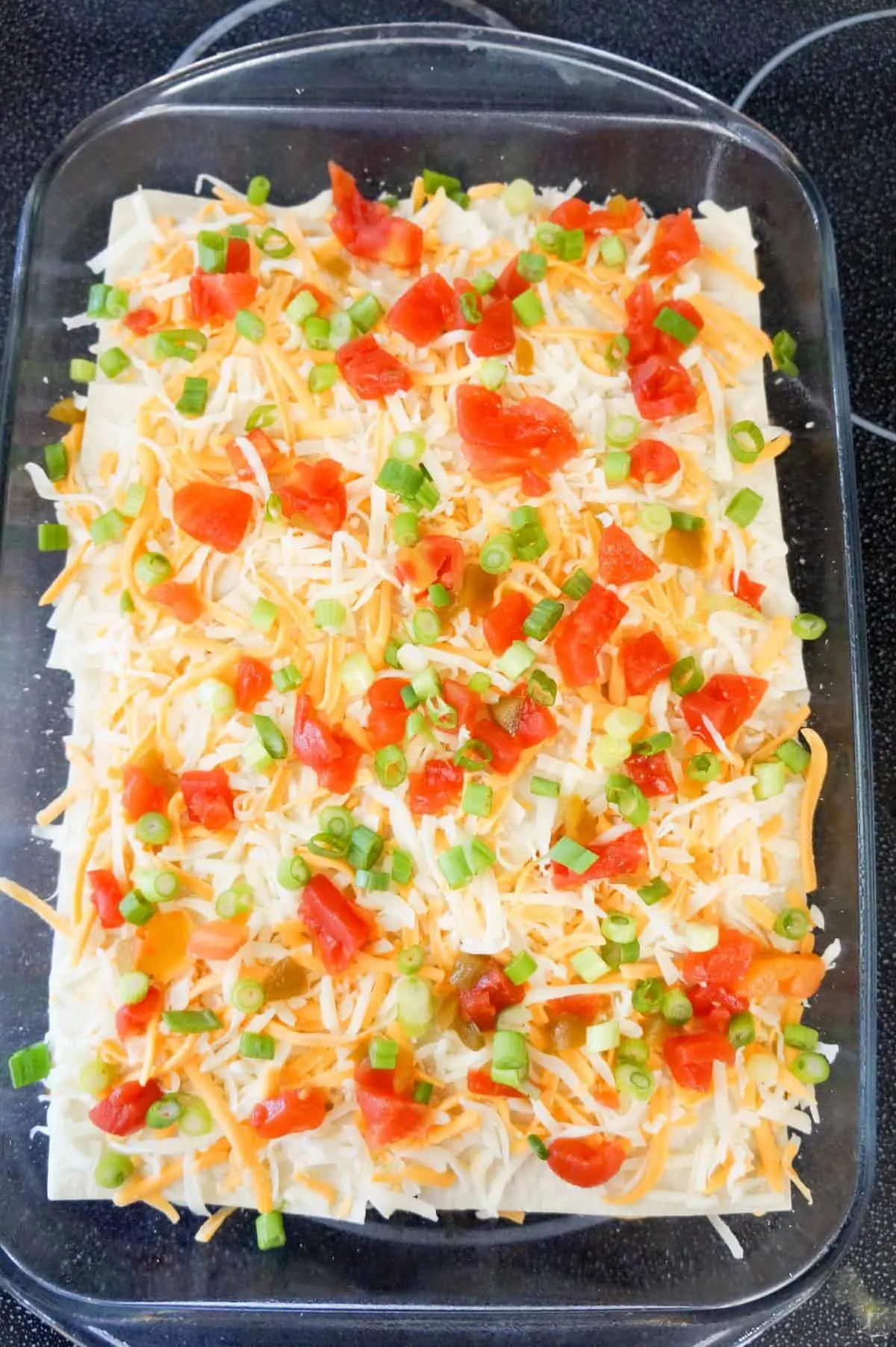 rotel, chopped green onions and shredded cheese on top of taco lasagna before baking