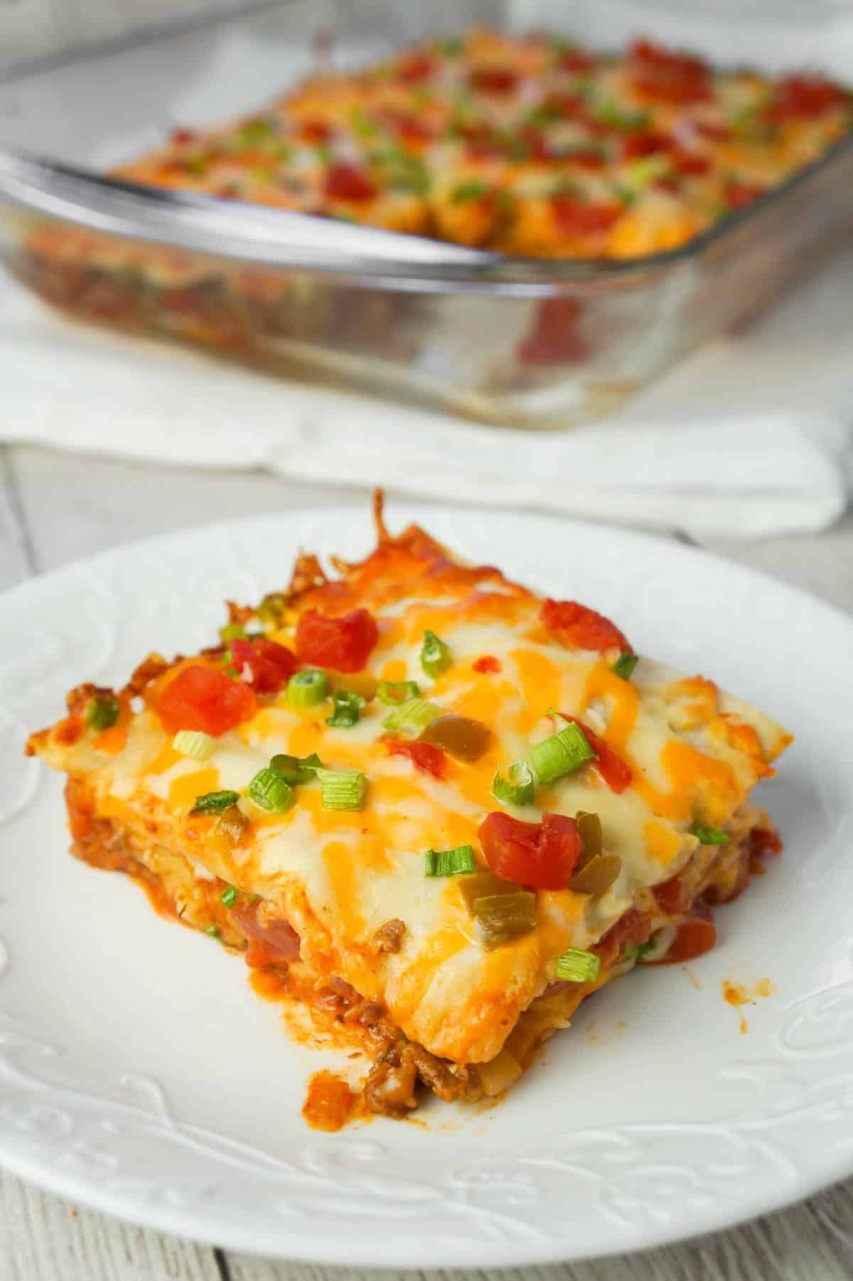 Taco Lasagna is an easy casserole recipe with layers of soft tortillas, shredded cheese, ground beef and salsa.