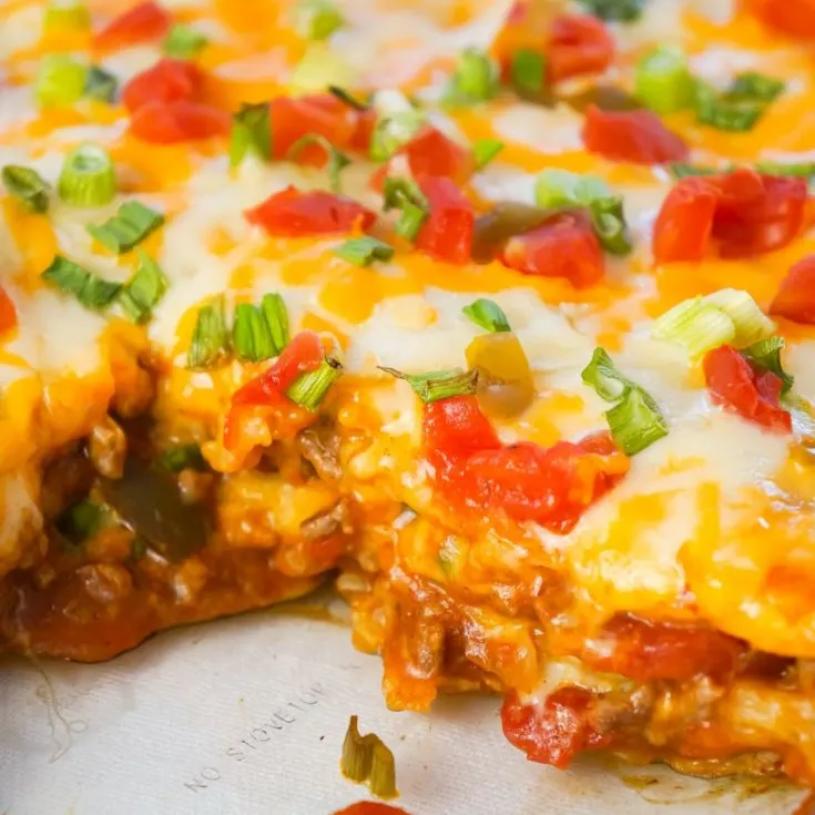 Taco Lasagna is an easy casserole recipe with layers of soft tortillas, shredded cheese, ground beef and salsa.