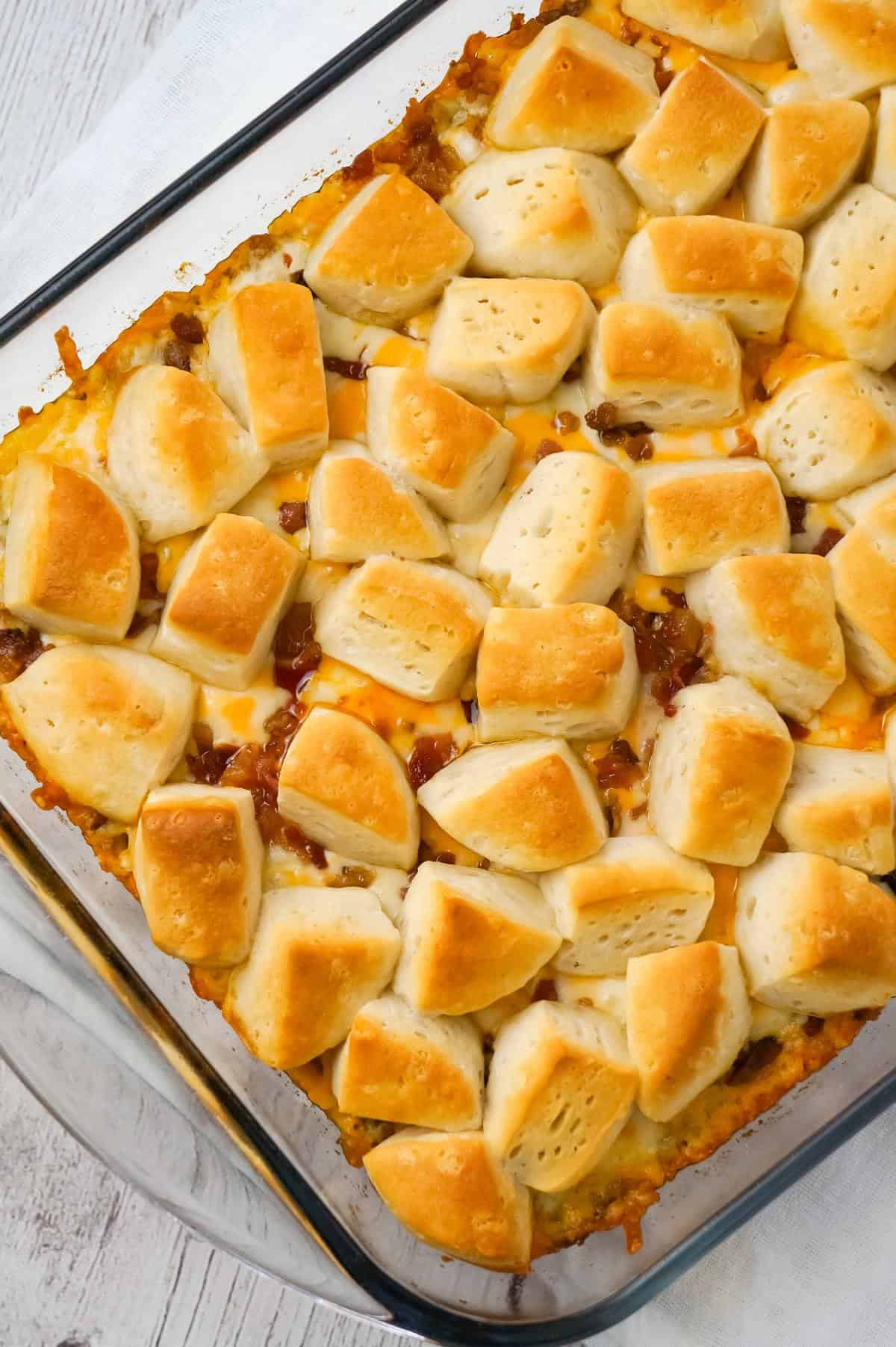 Bacon Cheeseburger Biscuit Casserole is an easy ground beef dinner recipe loaded with diced onions, condensed cheddar cheese soup, ketchup, mustard, crumbled bacon and shredded cheese all topped with pieces of Pillsbury biscuits.